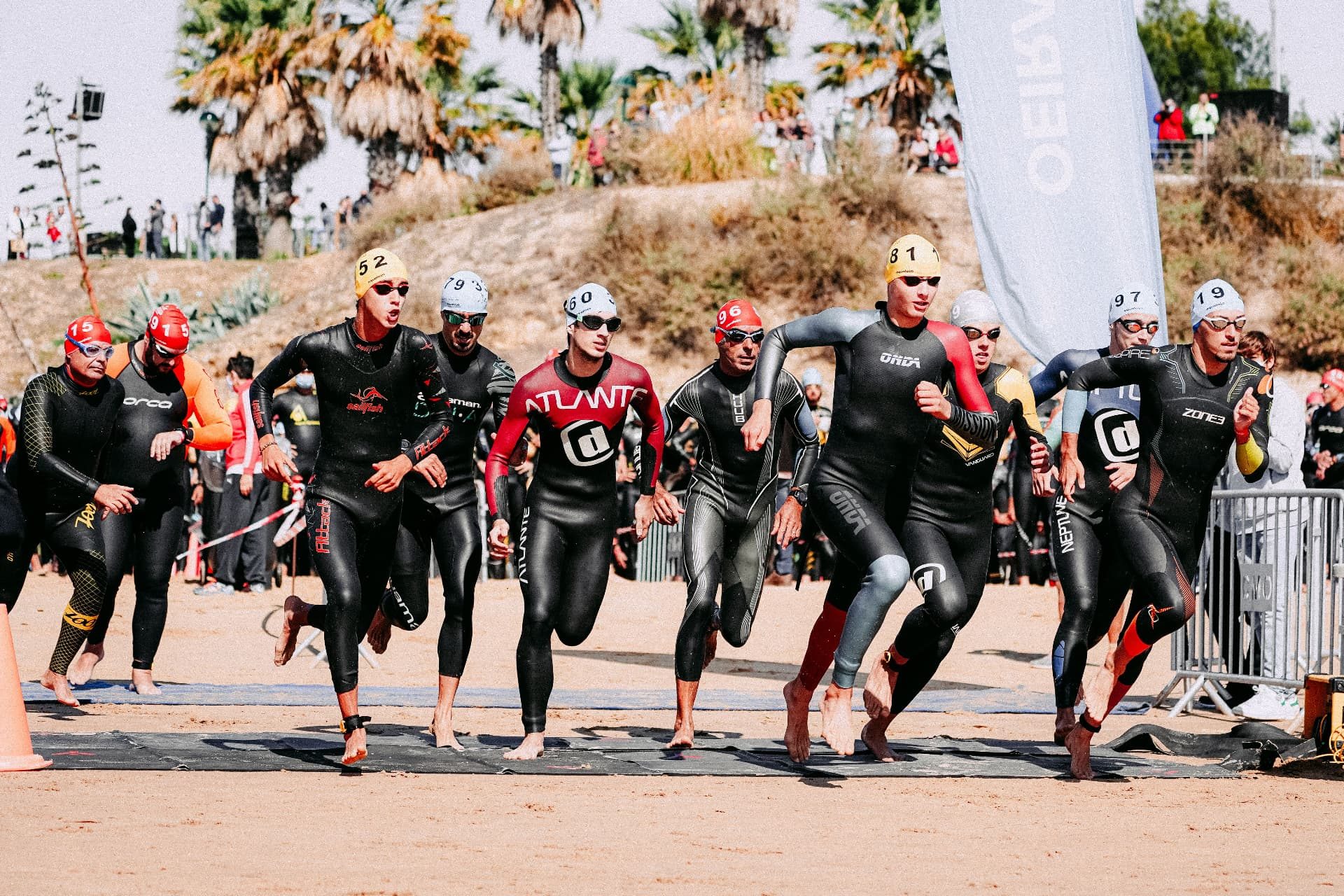 Athletes entering the water at the swim start